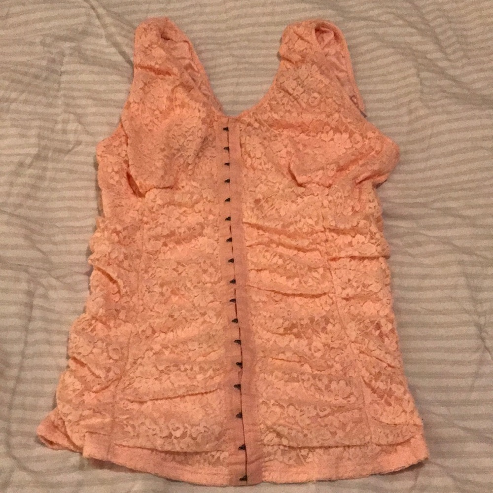 Lace corset top. The color of the top is pink.